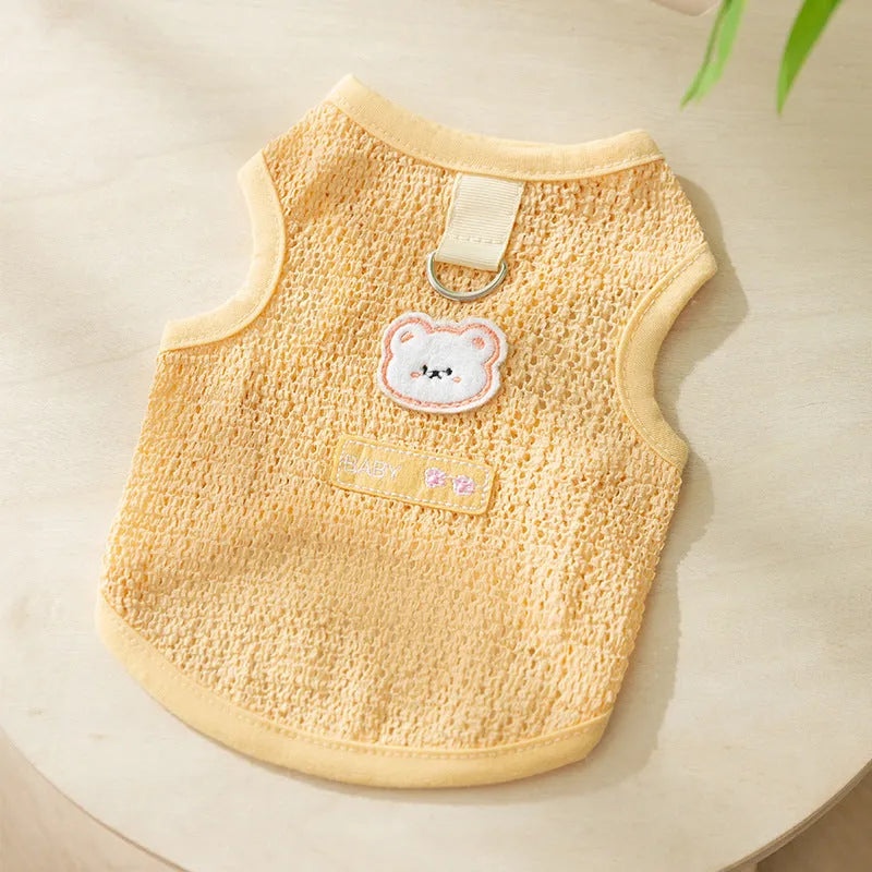 Green knitted cat clothing with bear patch design showing hollowed-out breathable fabric construction
