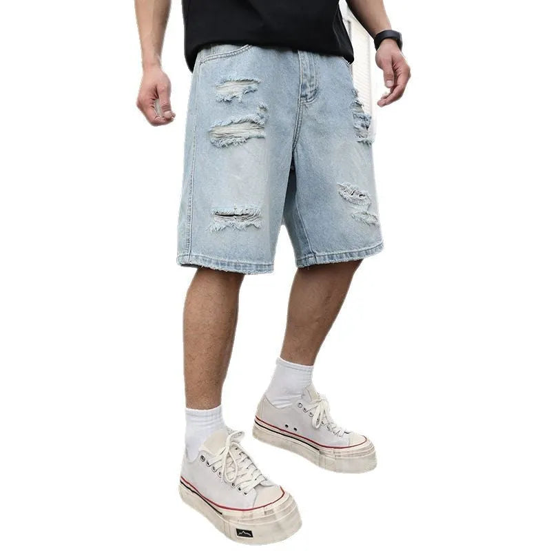 Men's light blue loose fit ripped denim shorts with distressed detailing and straight cut hip hop style