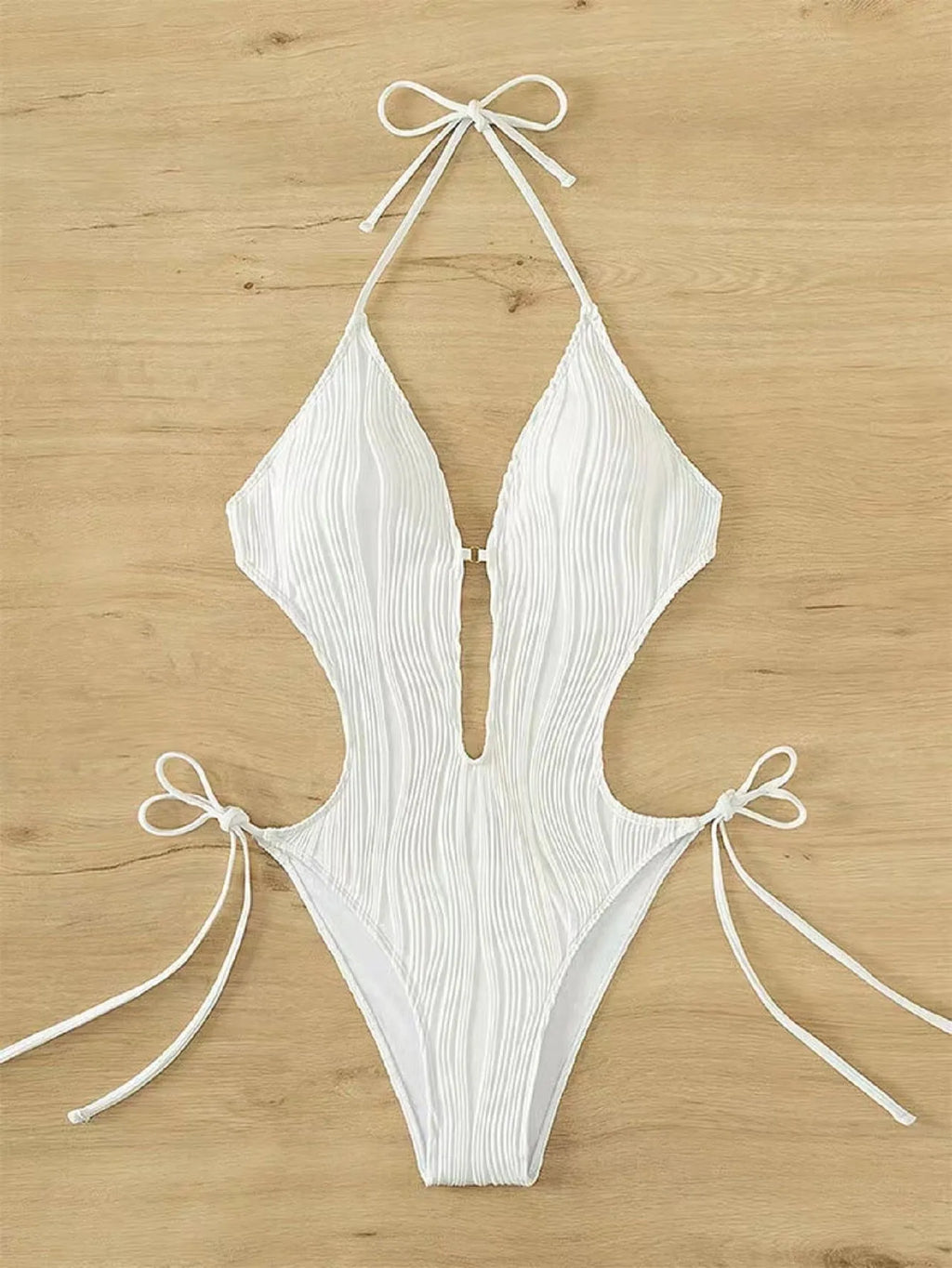 Women's black triangle bikini with white lace-up fastening detail on the front