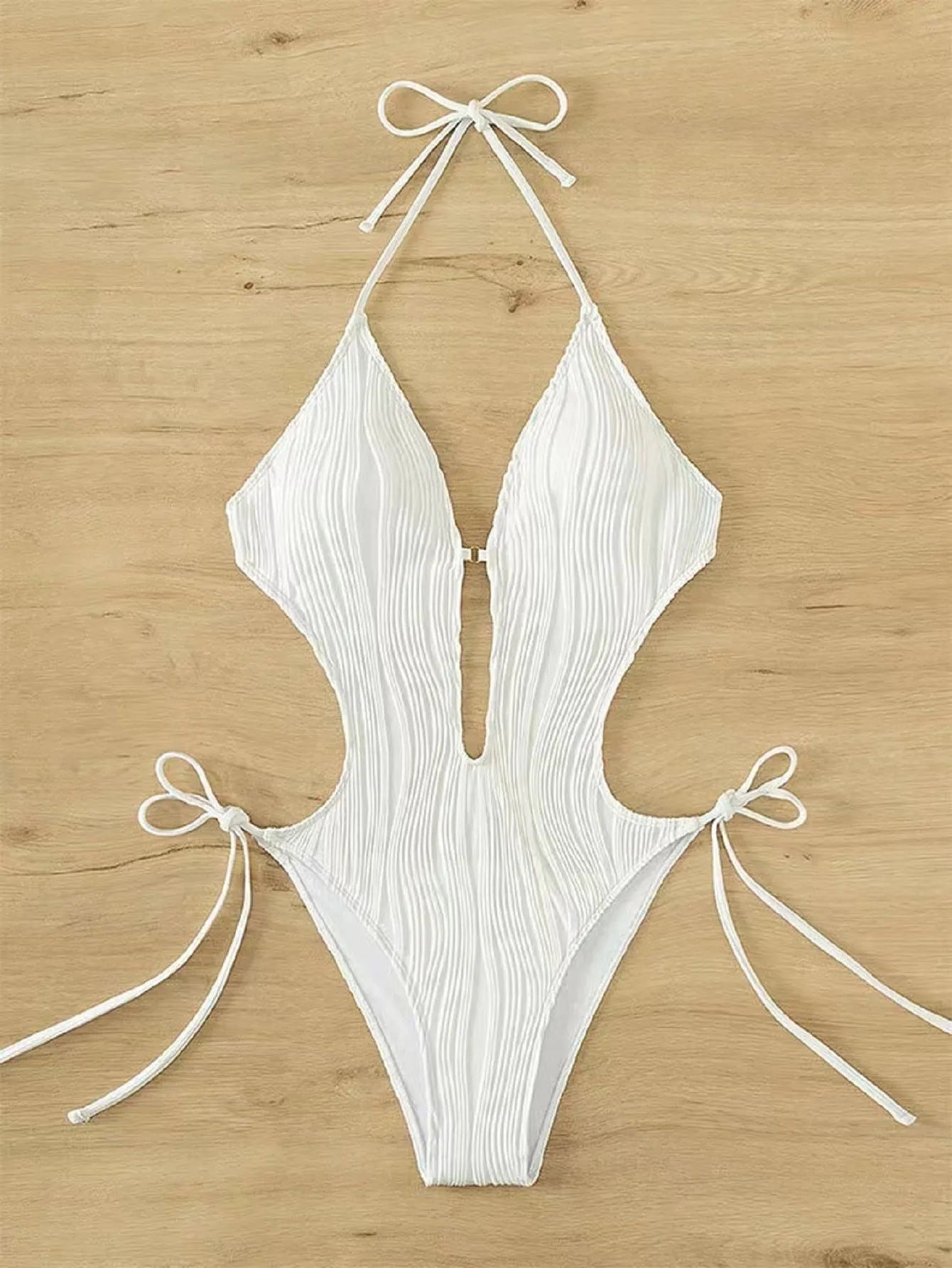 Women's black triangle bikini with white lace-up fastening detail on the front