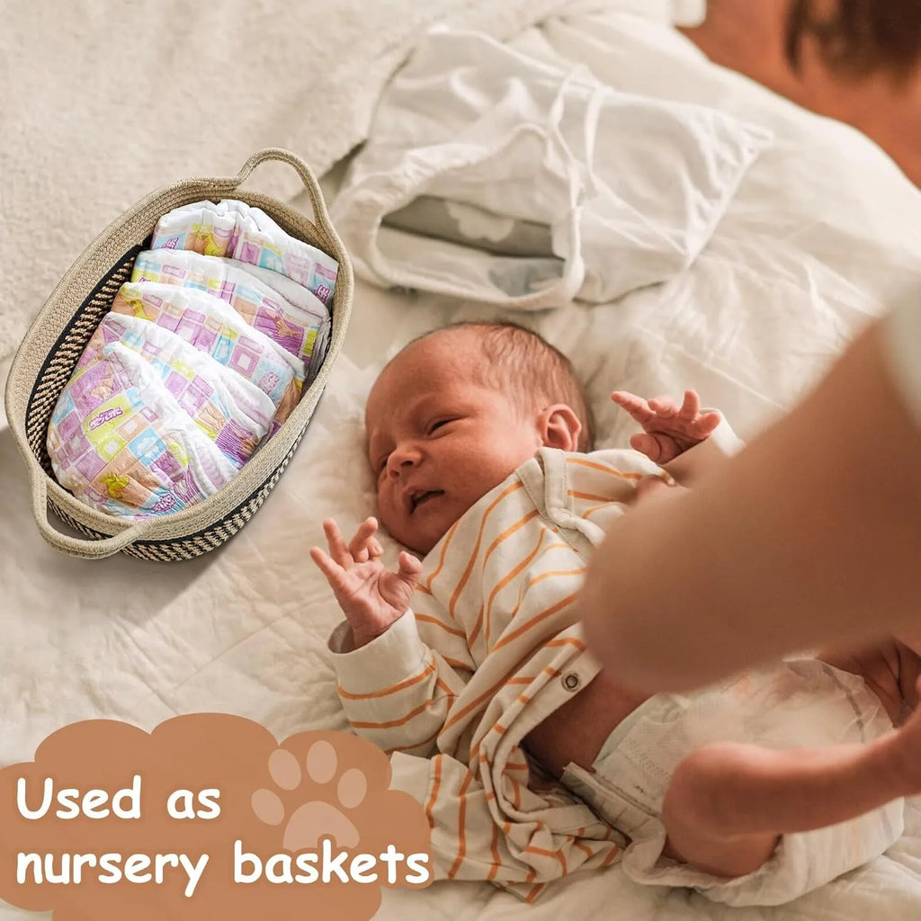 Light beige handmade cotton rope woven storage basket with wooden accents and handles.