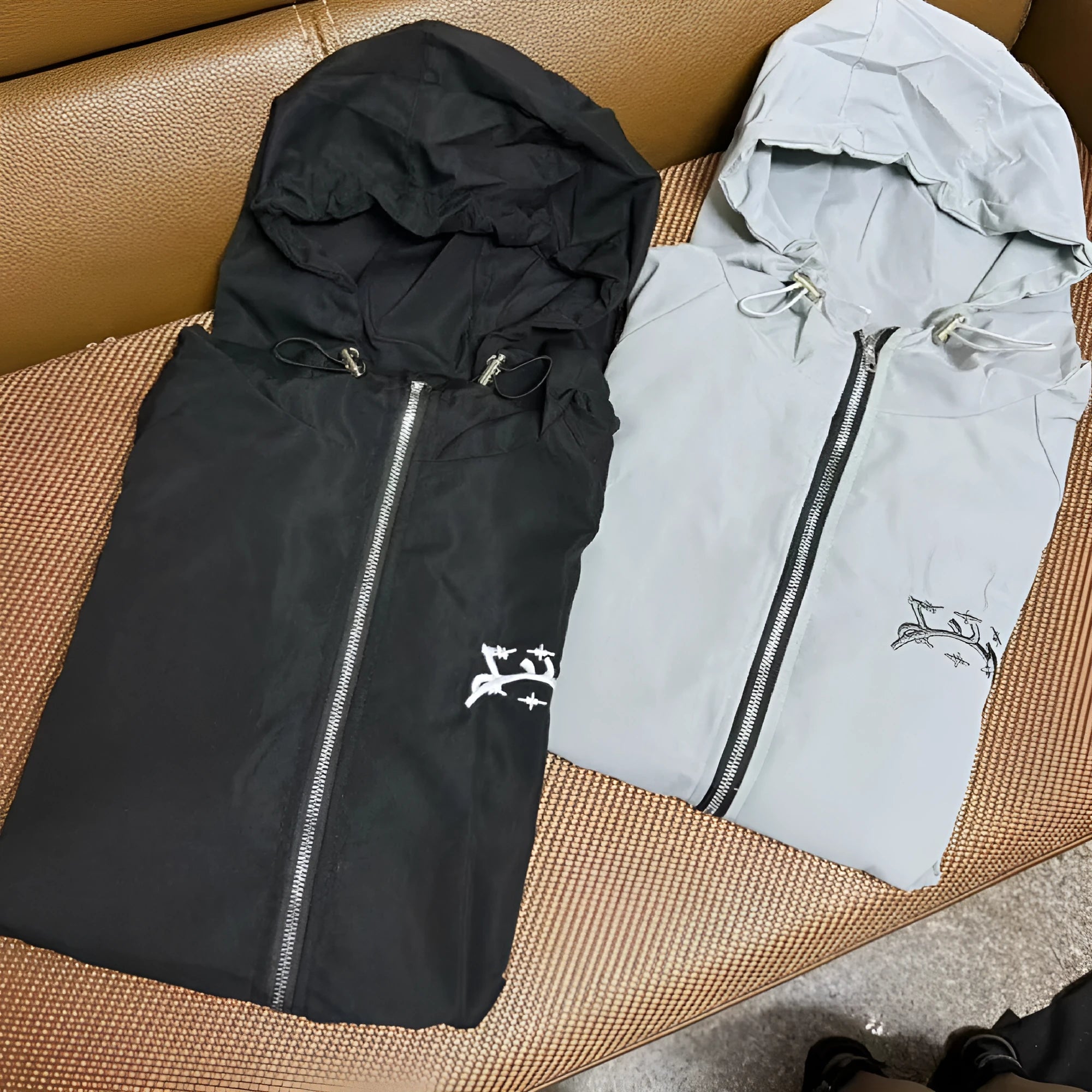 Men's grey hooded sunscreen jacket showing loose British style fit and polyester fabric construction