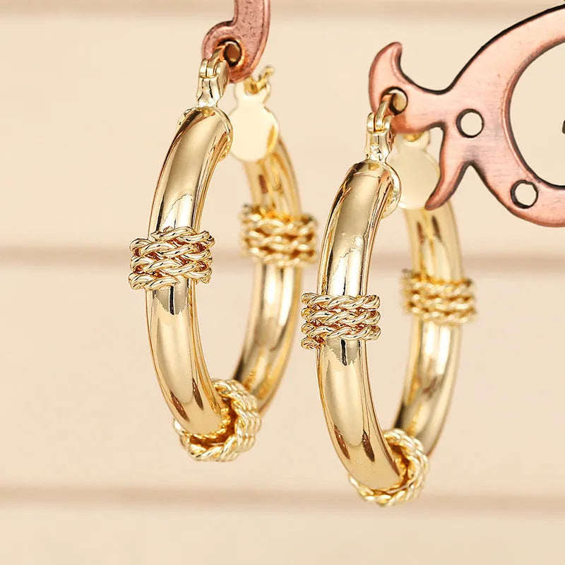 Geometric copper earrings with ring and line design in golden colour