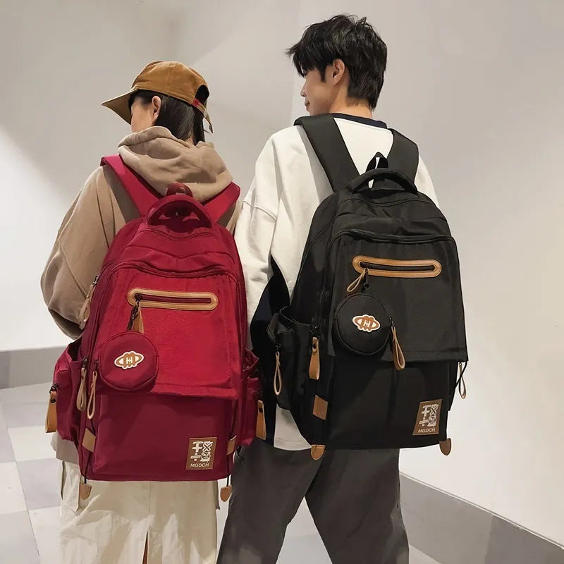 Large black nylon backpack for middle school students with curved shoulder straps.