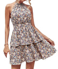 Woman wearing a backless halter neck A-line summer dress with boho ruffled print.