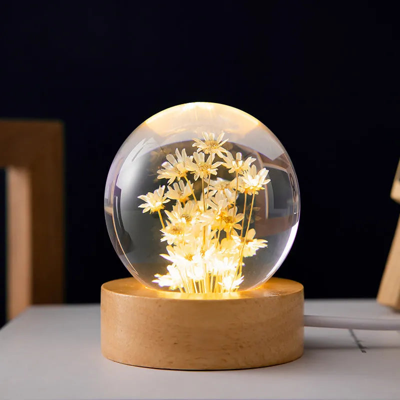 Preserved dandelion inside a glowing resin crystal ball night light on a beech wood stand.