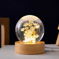 Preserved dandelion inside a glowing resin crystal ball night light on a beech wood stand.