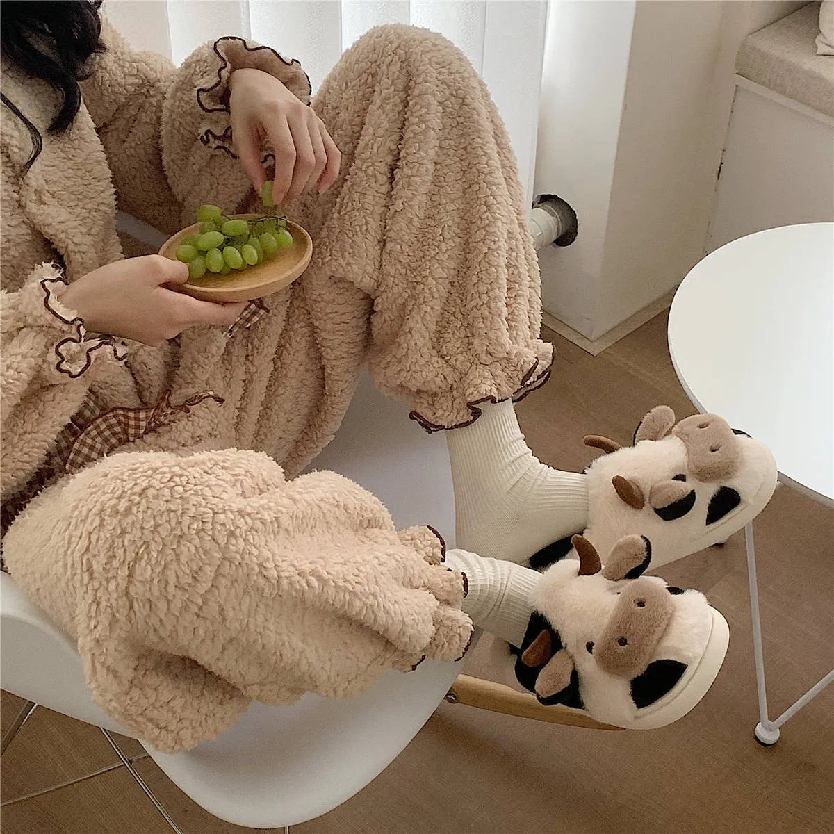 White women's cow slippers with plush faux fur upper and textured non-slip soles