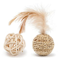 Two cat toy balls: one rattan sphere and one colourful faux feather ball with bell on a neutral background