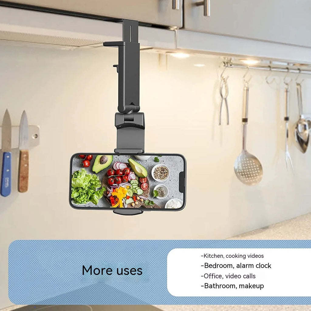 Black foldable rotating phone holder holding a mobile phone on a desk.