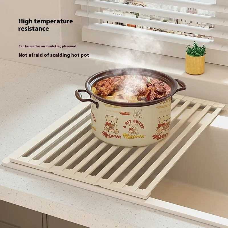 Foldable milky white stainless steel kitchen draining rack shown extended over a sink.