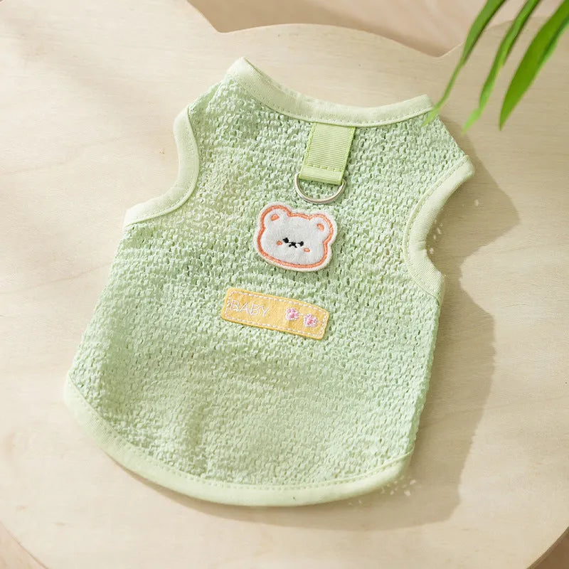 Green knitted cat clothing with bear patch design showing hollowed-out breathable fabric construction
