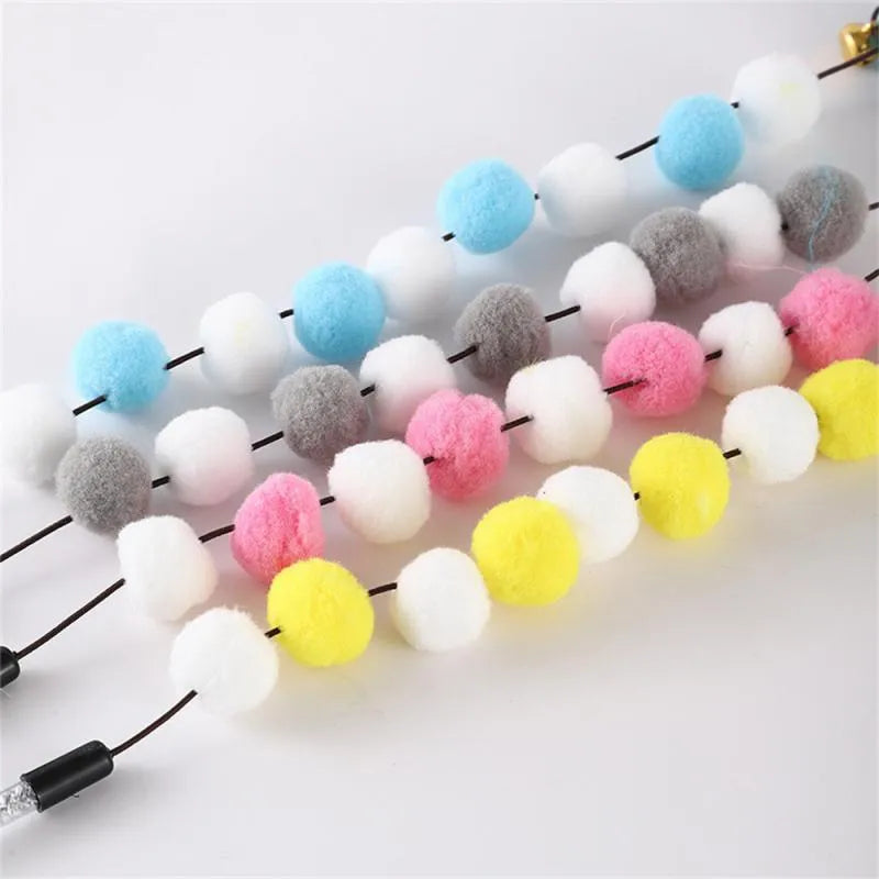 Grey, yellow, and blue cat teaser toy rod with feather, pompon, and bell measuring 31cm.
