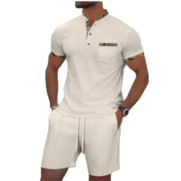 Man wearing a grey zip-front polo collar short sleeve top and matching shorts from a cotton blend suit set.