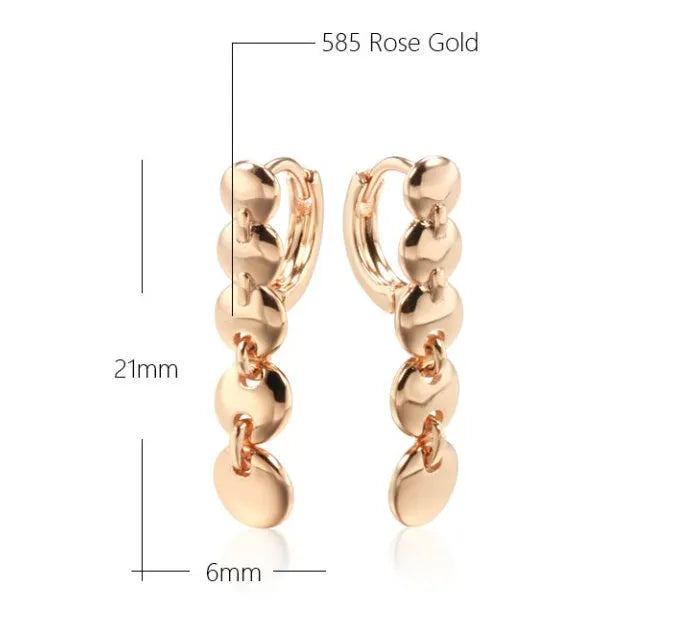 Gold tone retro earrings with a round circle shape and surface weave design, hanging as a dangle.
