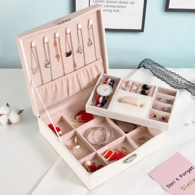 Red and white jewellery storage box with compartments for necklaces and rings