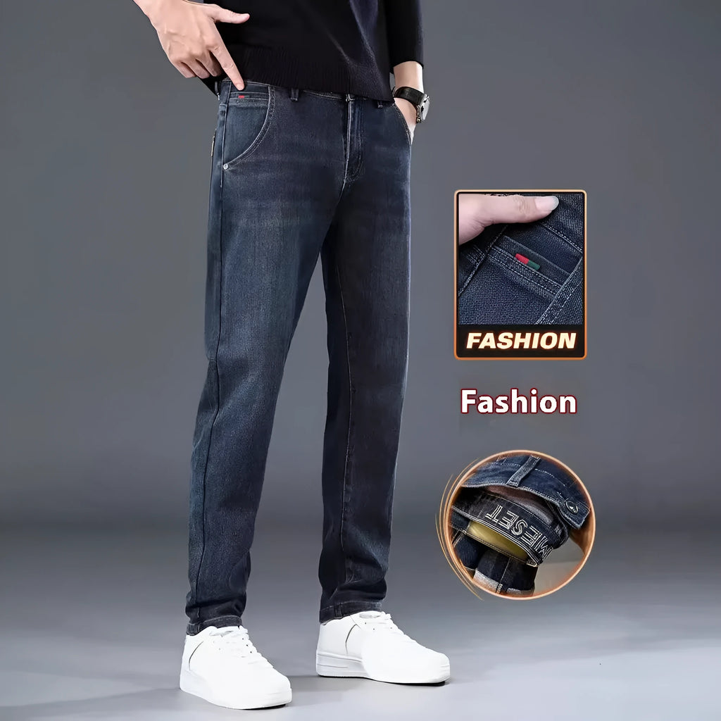 Man wearing blue grey slim straight casual trousers with a loose fit for summer street fashion.