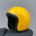 Glass fibre motorcycle half helmet shown in a retro style on a stand.