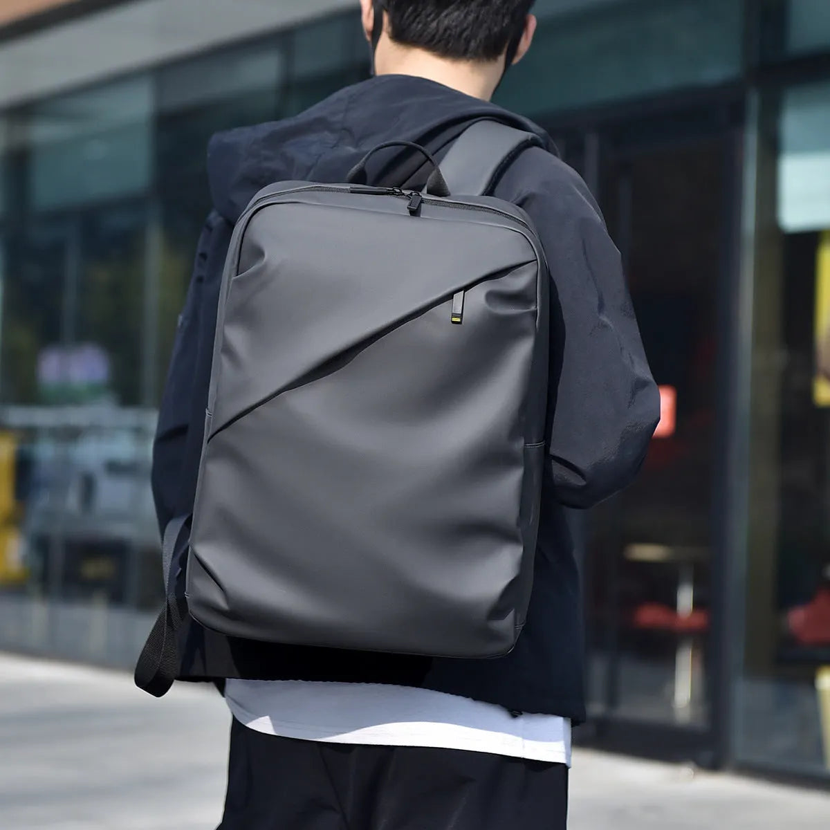 Waterproof PU leather backpack with sewing thread details in black, blue, and grey colour options