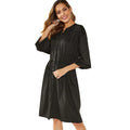 Black or red A-line mid-length dress with elastic waist, long sleeves with elastic cuffs, and a loose cinching belt.
