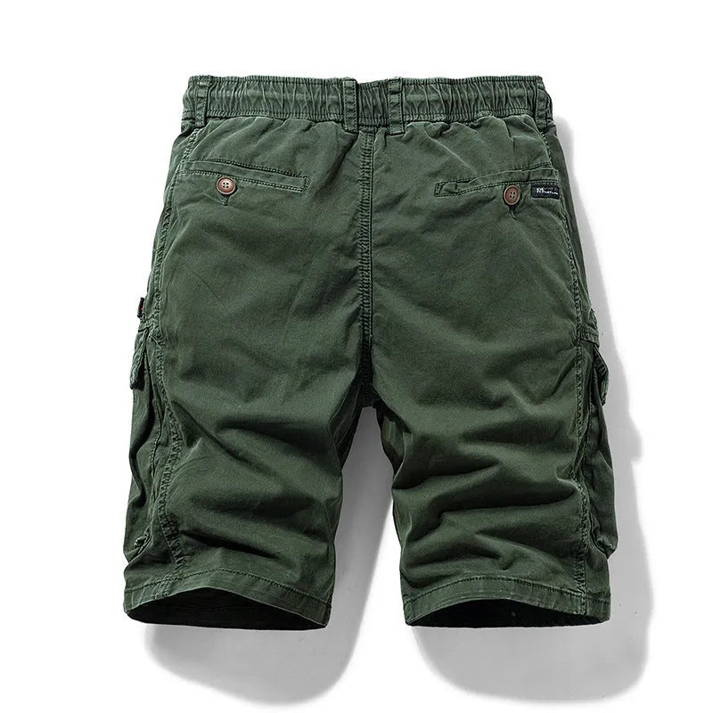 Men's army green cotton shorts with multiple zip pockets, shown with a Korean-style above-the-knee cut.