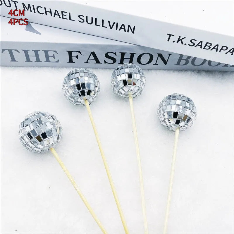 Glass mirror disco ball cake topper on a wooden stick for birthday party cupcakes.