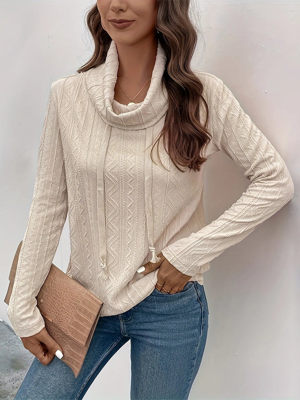 Apricot coloured hooded pullover sweater with long sleeves and a drawstring on the hood.