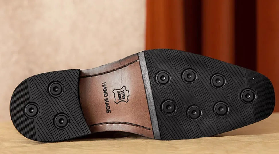 Men's black genuine leather slip-on loafers with fringed detailing on a white background