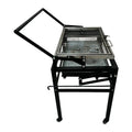 Large foldable and detachable charcoal BBQ grill oven set up in an outdoor courtyard setting.