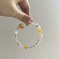 Mixed material alloy bracelet with diamond elements and round detailing in Orange Sea Summer colour