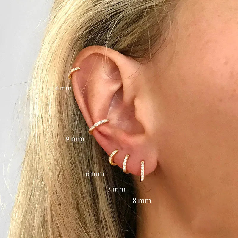 Perforated circle zircon stud earrings in gold, rose gold, or silver colour on white background