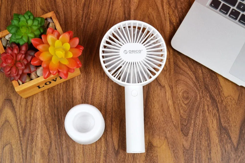 White ORICO FH1 portable USB rechargeable desk fan showing three-speed buttons and compact design