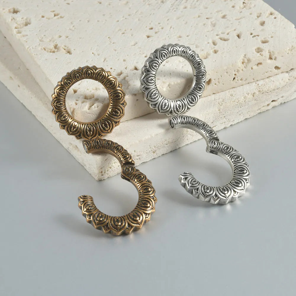 Retro stainless steel magnetic earrings in hollow heart and lotus shapes with antique silver and gold finishes.