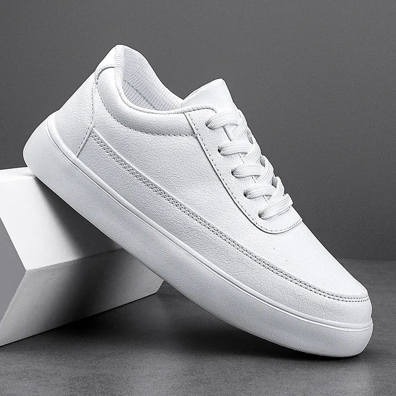 Women's white leather lace-up flat casual shoes on a plain background.