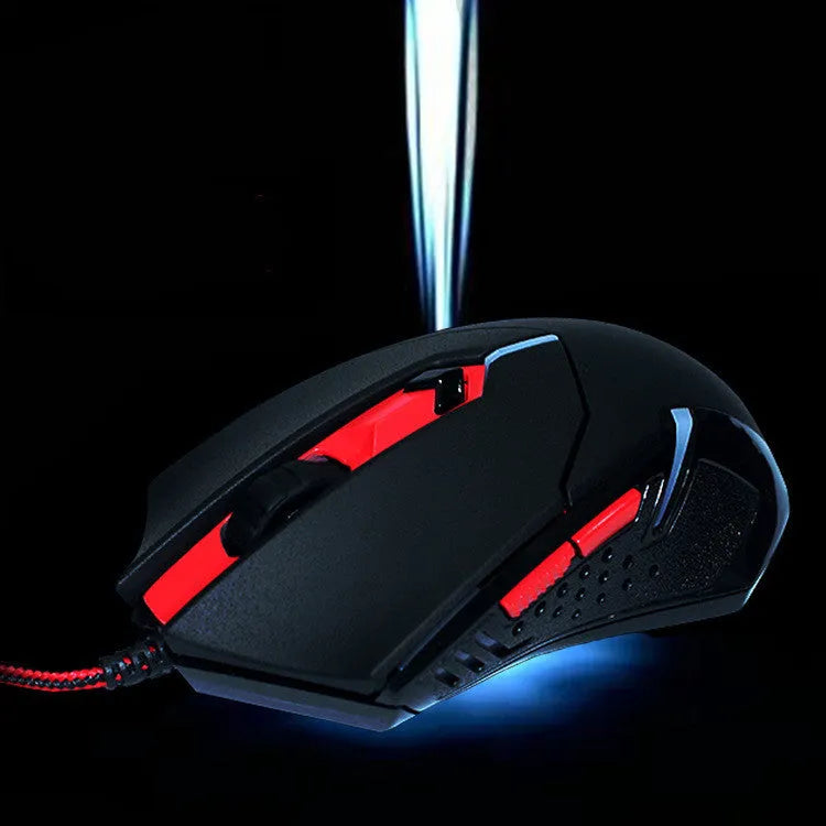 Black and red wired USB optical gaming mouse with six buttons on a desk.