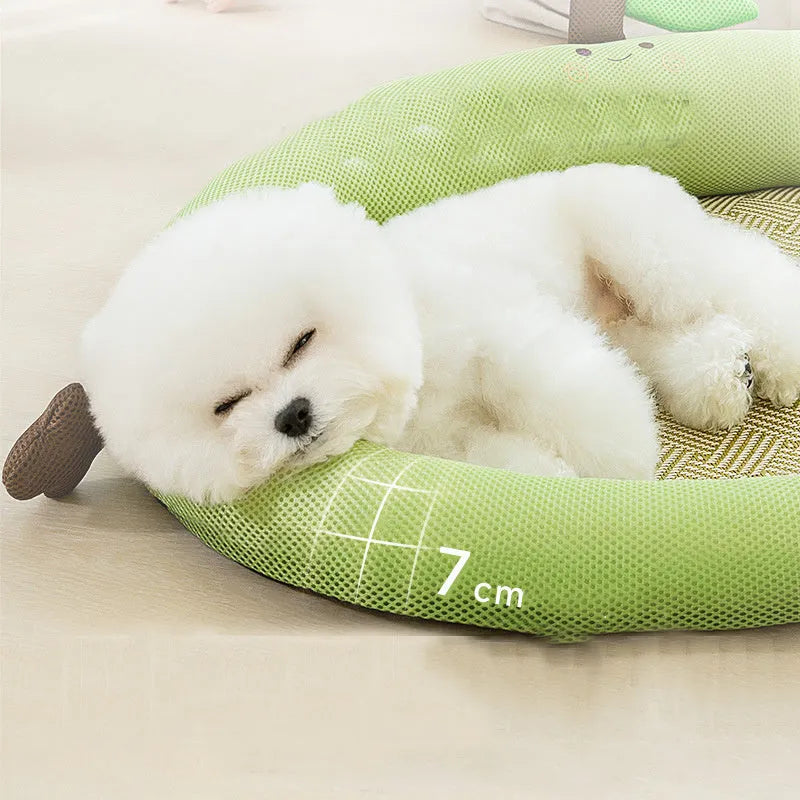 Green large pet bed nest with a raised fruit-shaped backrest for dogs on a wooden floor.