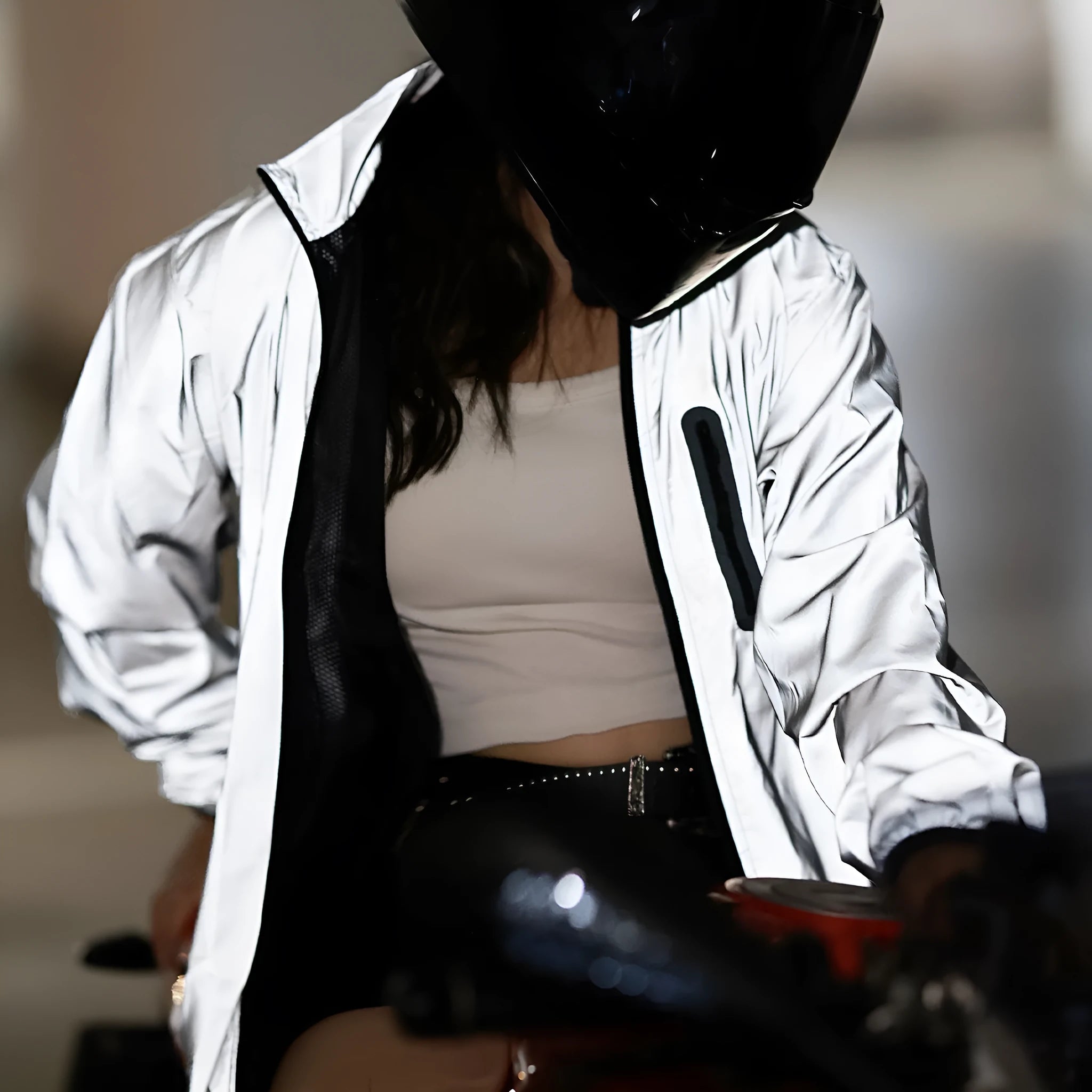 Silver coloured waterproof polyester long sleeve jacket for men on a hanger.