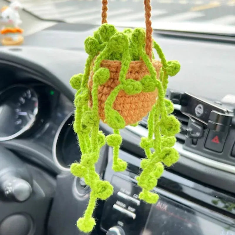 Knitted green and white car plant decoration with hanging rope