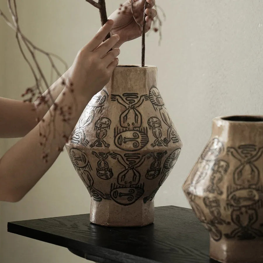 Ceramic vase with hand-painted vintage carved tribal totem art in religious symbolic patterns