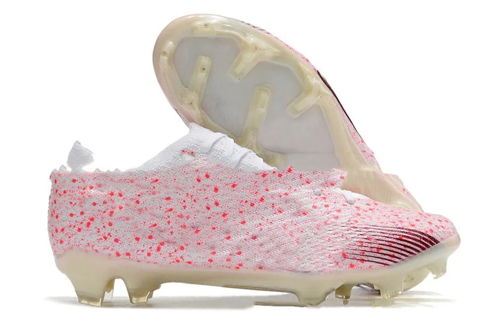 Men's black football shoes with knitted upper, lace-up closure, and rubber FG stud sole