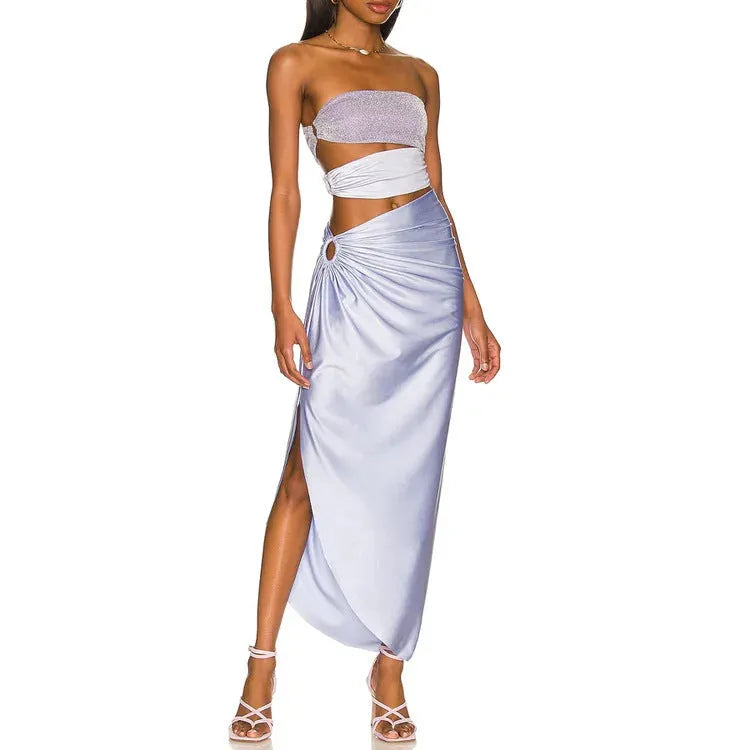 Purple one-piece swimsuit with hollow back and matching wrap skirt laid flat.