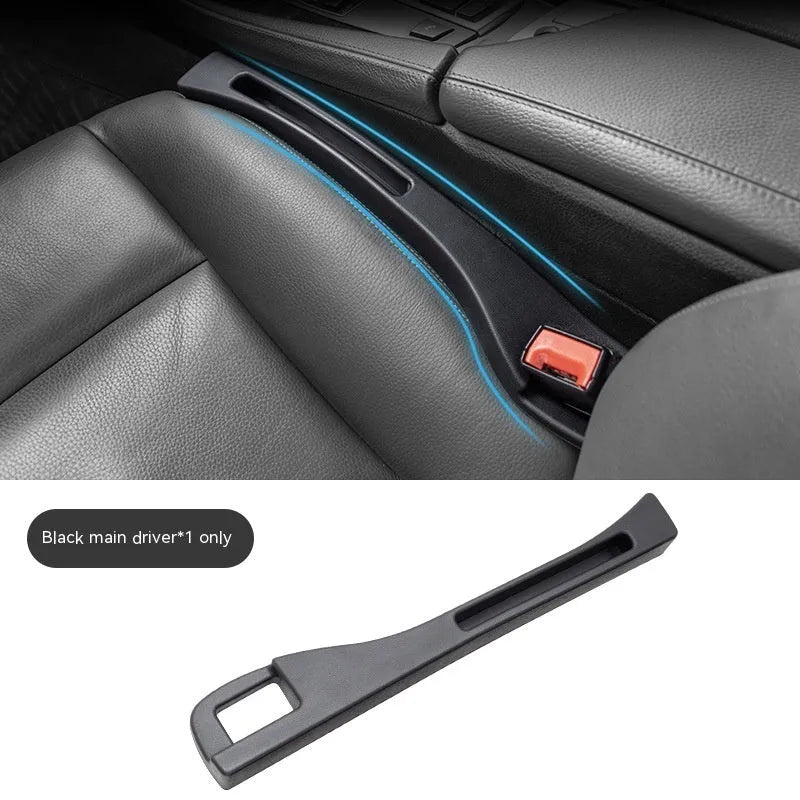 Black plastic car seat gap storage box with removal handle inserted between vehicle seats