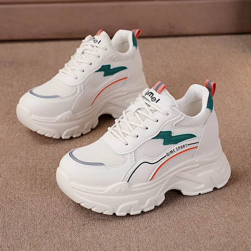 Women's white and beige dad shoes with lace-up front and rubber sole showing mesh material detail