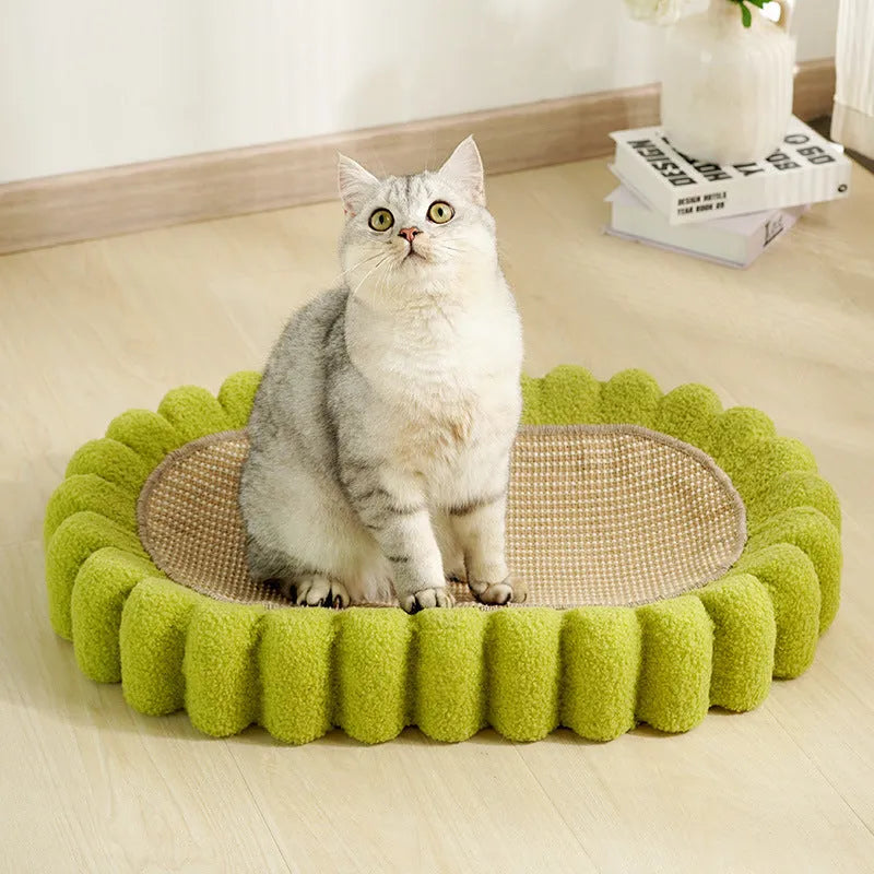 Green oval cat scratcher pad and bed made from sisal, measuring 65cm long.