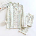 Red and white small fruit patterned cotton gauze long-sleeved top and trousers homewear set laid flat.
