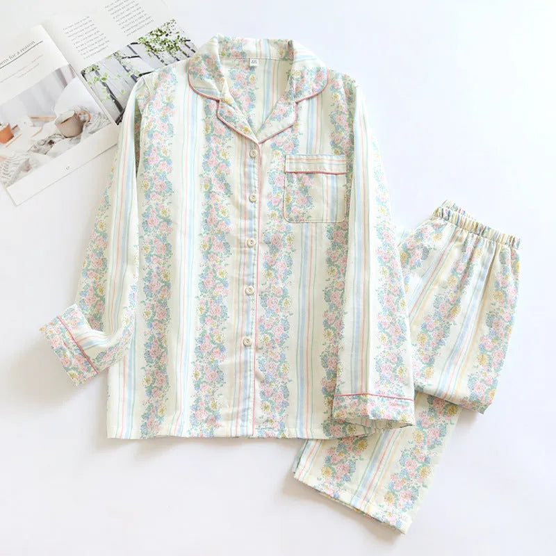 Red and white small fruit patterned cotton gauze long-sleeved top and trousers homewear set laid flat.