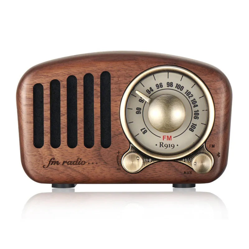 Retro wooden wireless mini Bluetooth speaker in cherry wood finish showing front speaker grille and controls