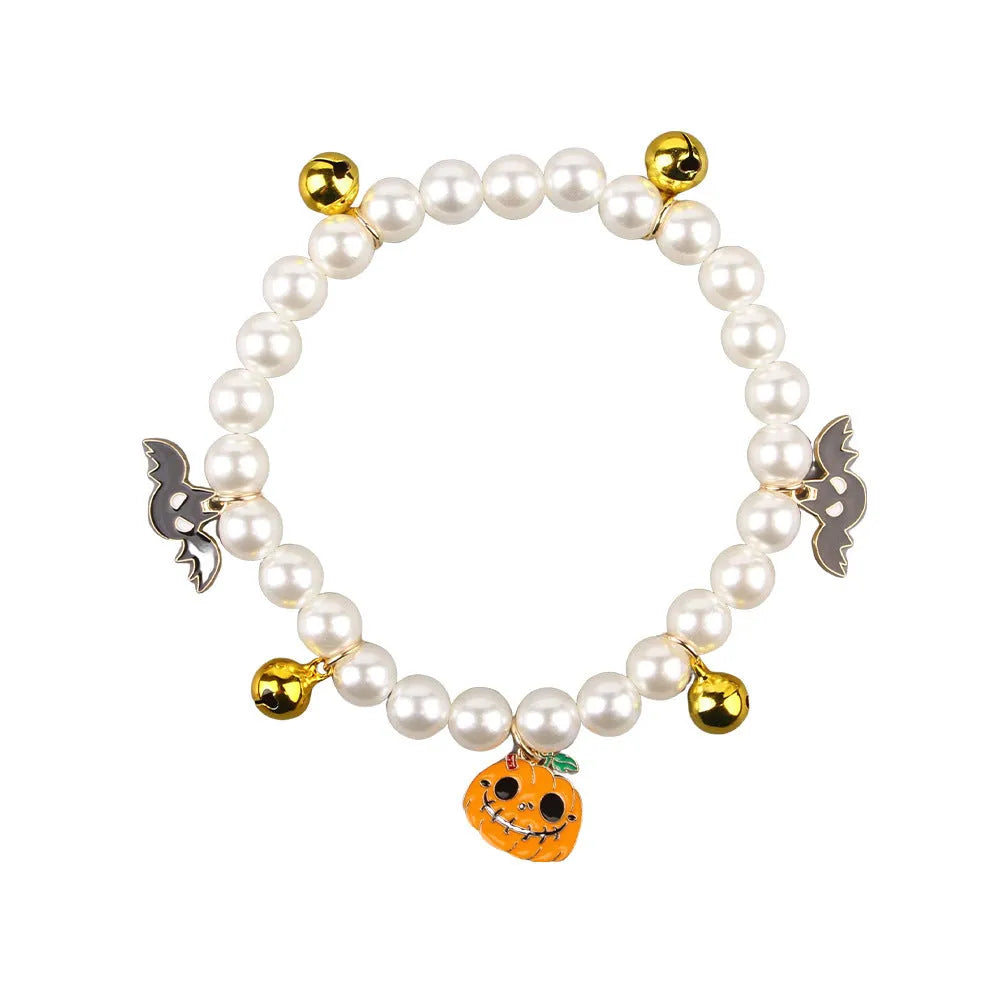 Halloween-themed cat collar with simulated pearl necklace decoration showing pumpkin designs