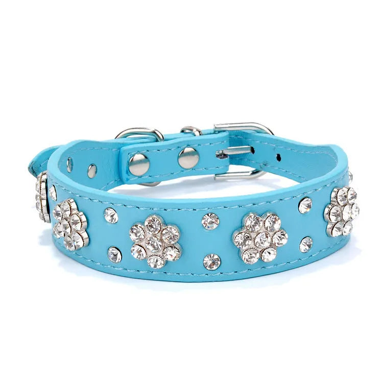 PU leather dog collar with rhinestone flower pattern and metal D-ring on a white background