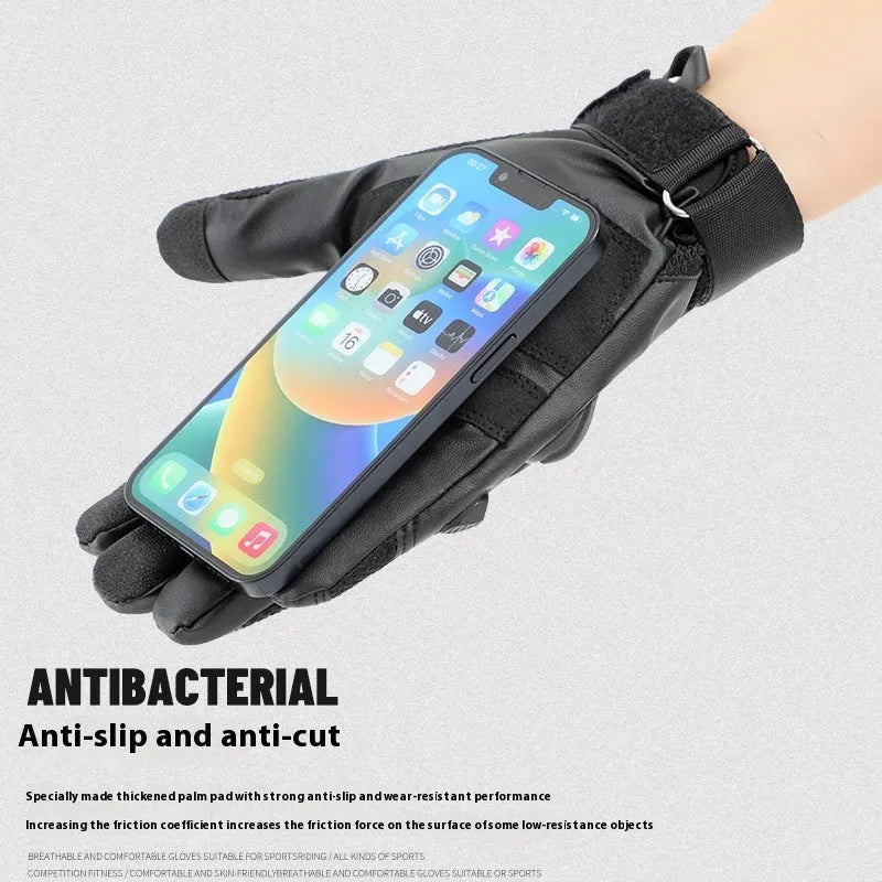 Men's black tactical gloves with touch screen fingertips on a hand holding a smartphone